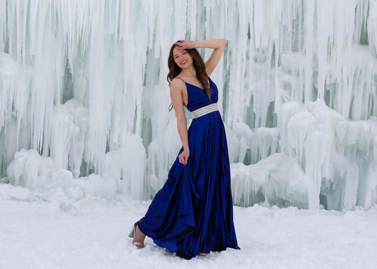 Midway Ice Castle senior photo of girl in dark blue prom dress and silver belt