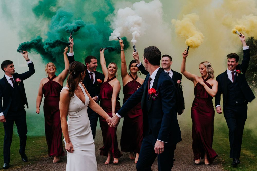 Bridal party with smoke bombs at a Gilmerton house wedding