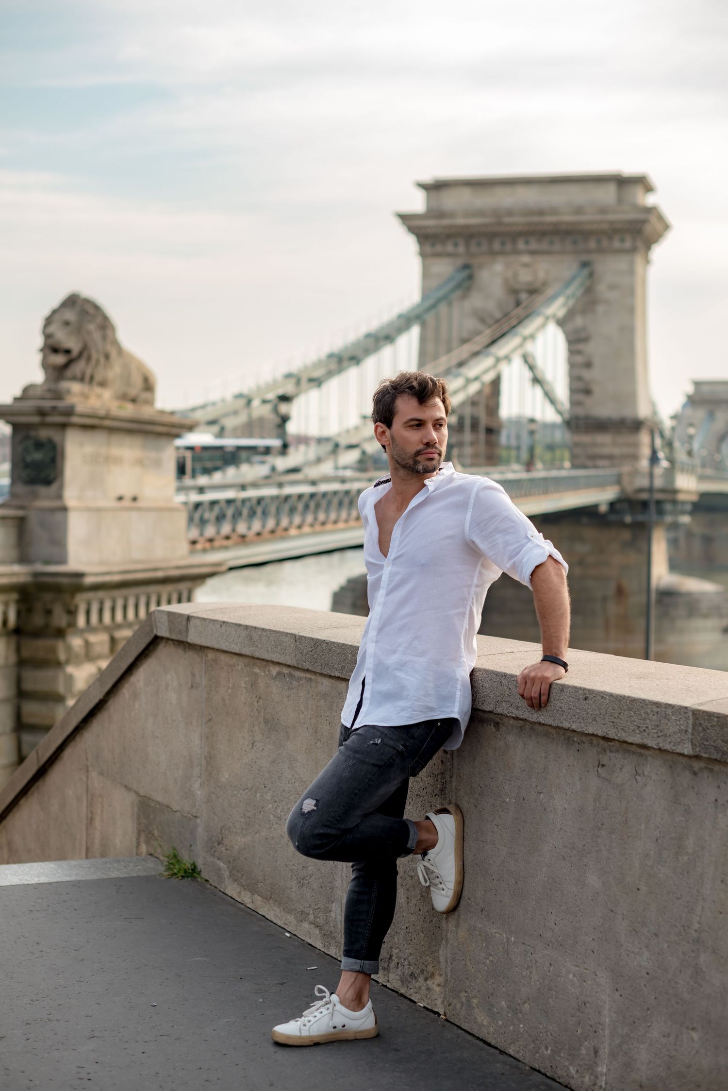 Solo traveler posing in front of chain bridge for a photo shoot with budapest photographer