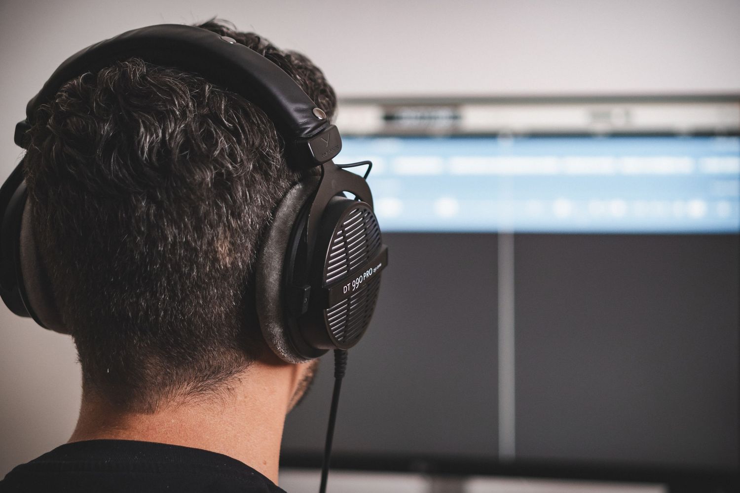 Recording studio equipment and monitors in professional audio workspace.