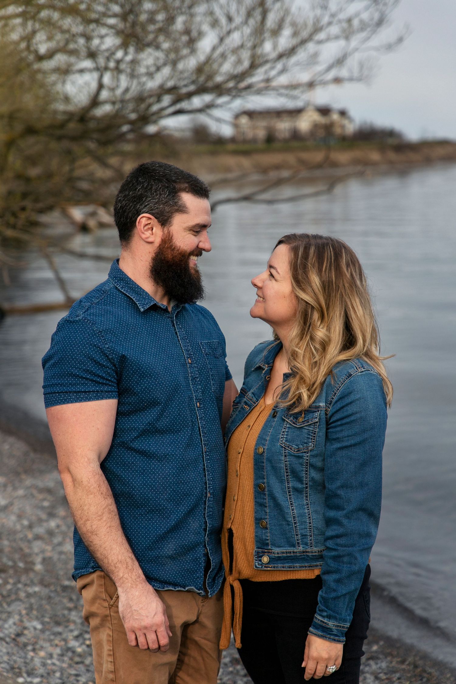 A husband and wife gazing into one anothers eyes at the Samuel Wilmot Nature Area beach