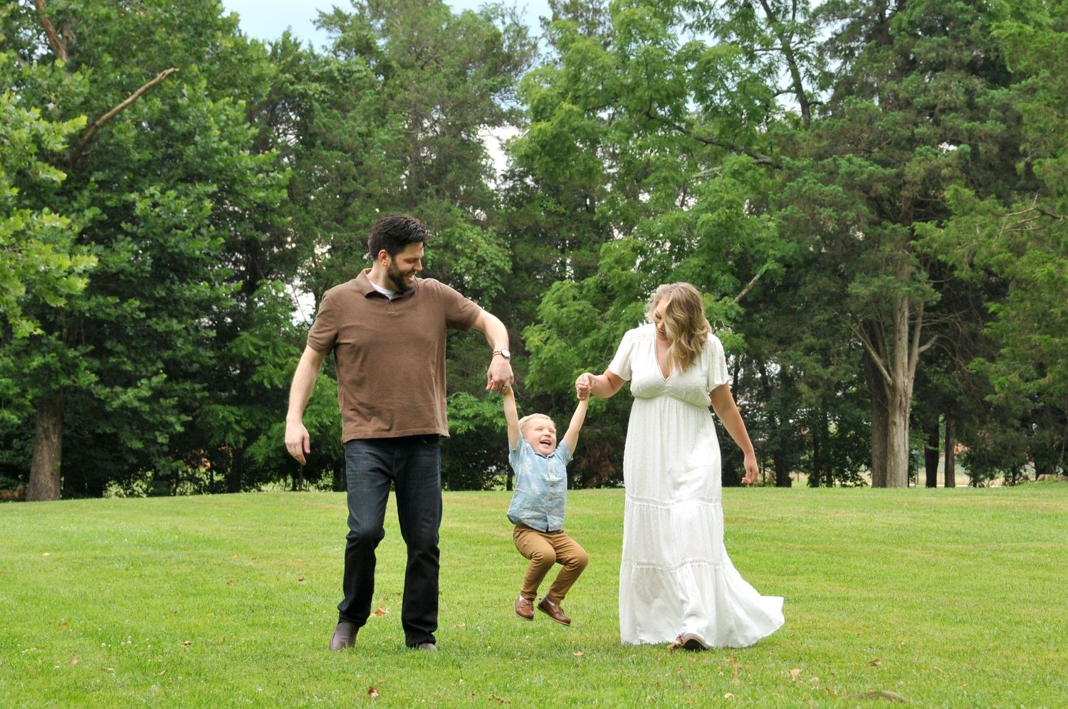 Family at Claude Moore Park with toddler jumping