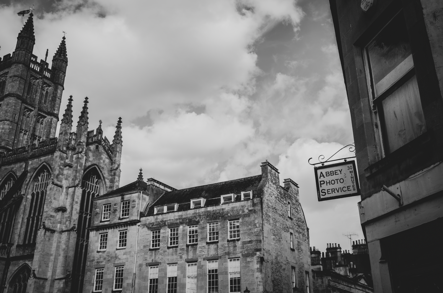 Black and white architectural photo of historic buildings with Gothic spires in Edinburgh.