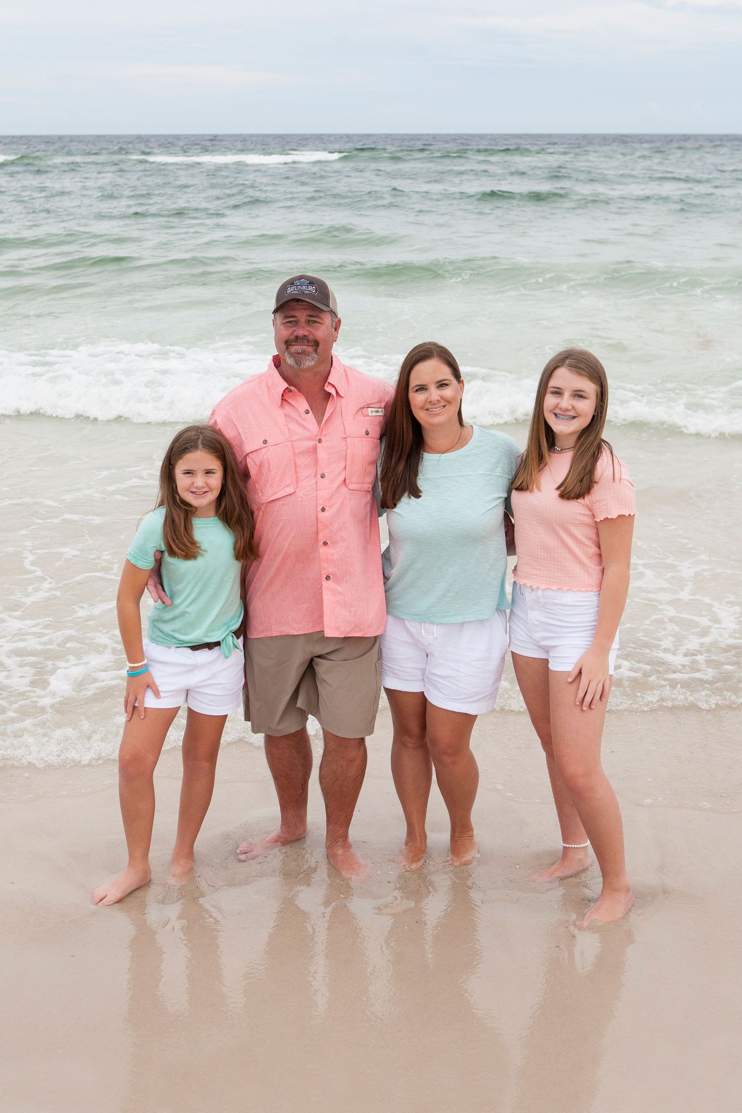 family on beach teal and coral