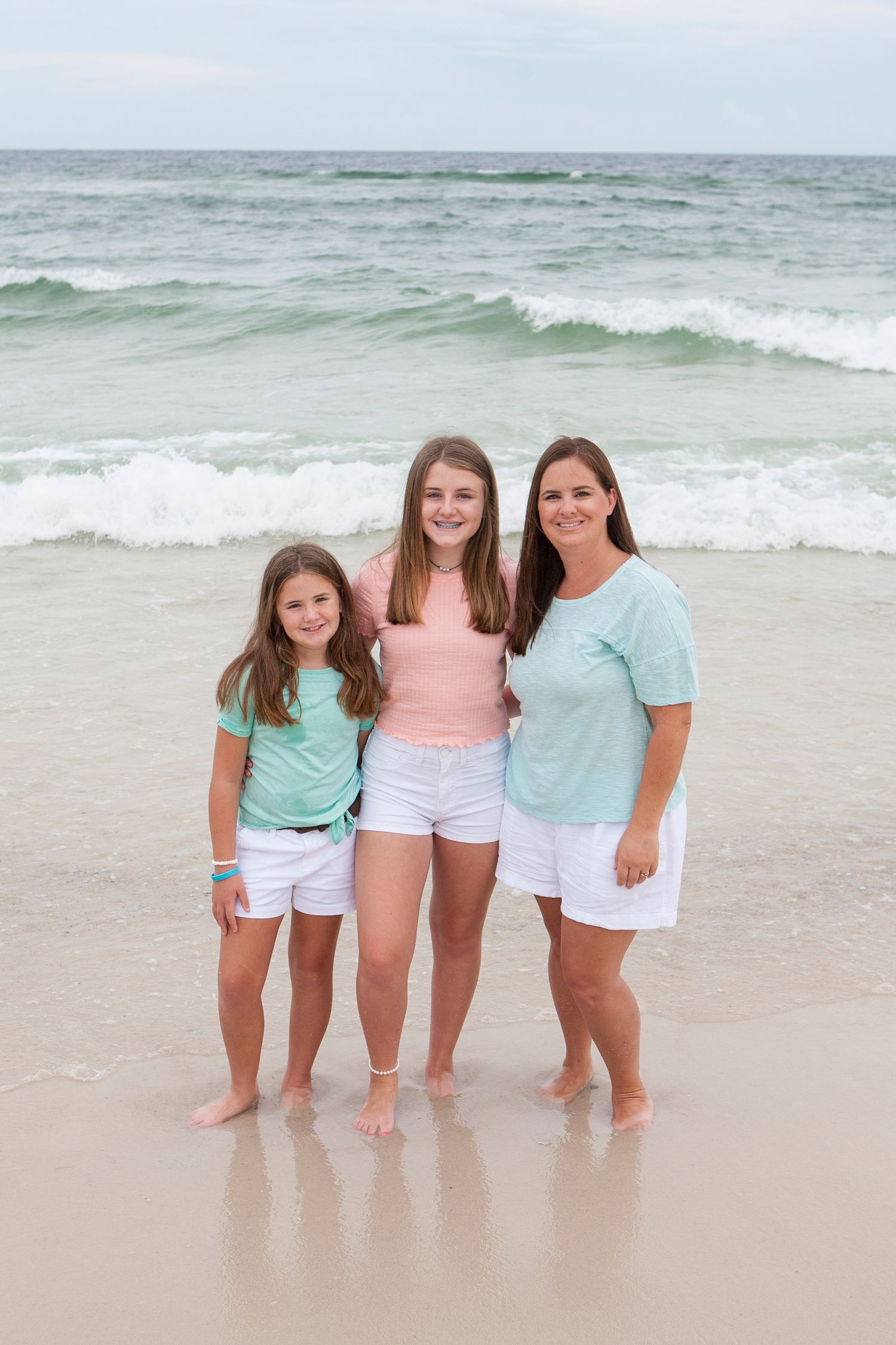 family on beach teal and coral