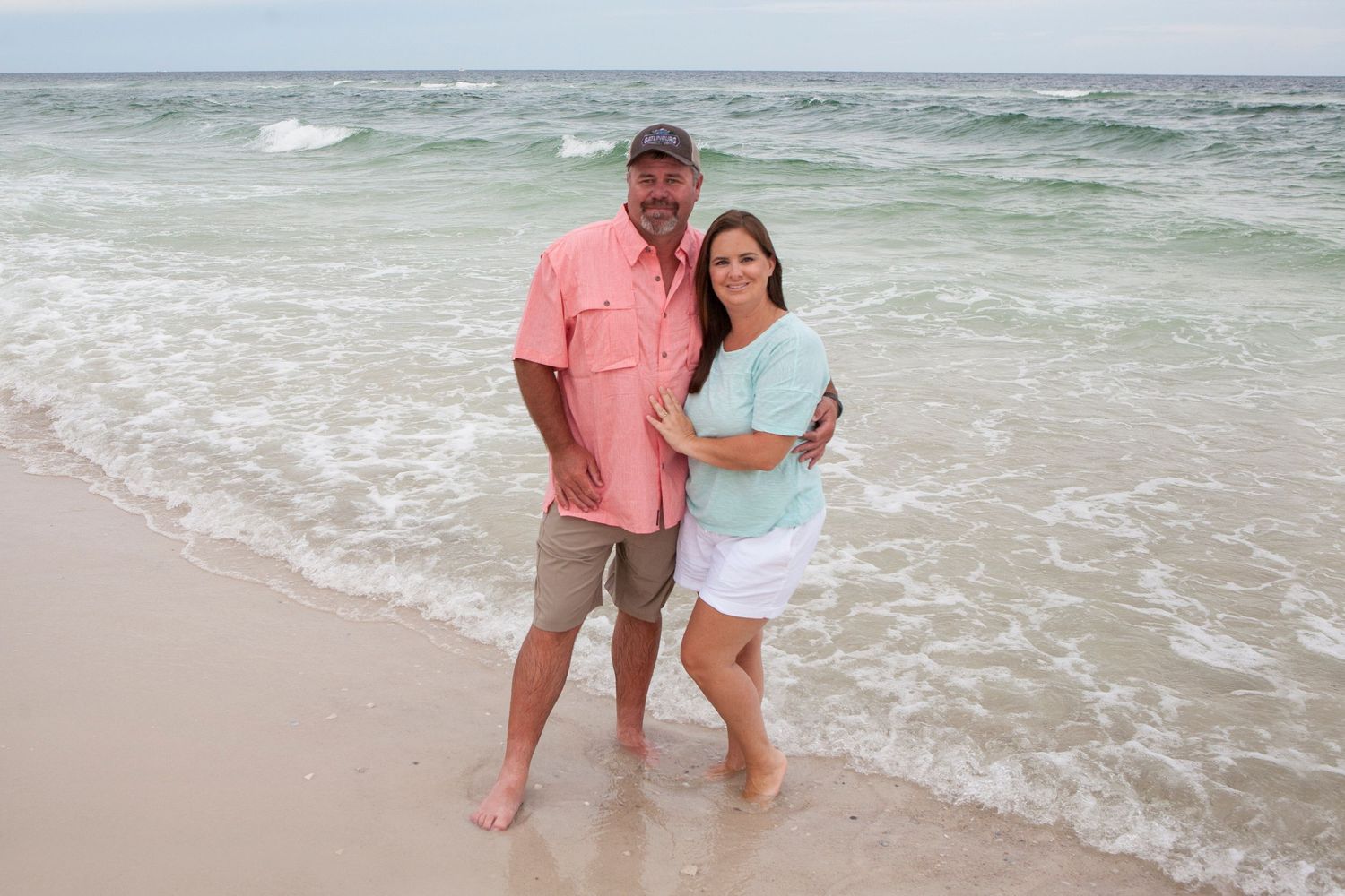 mom and dad on beach teal and coral