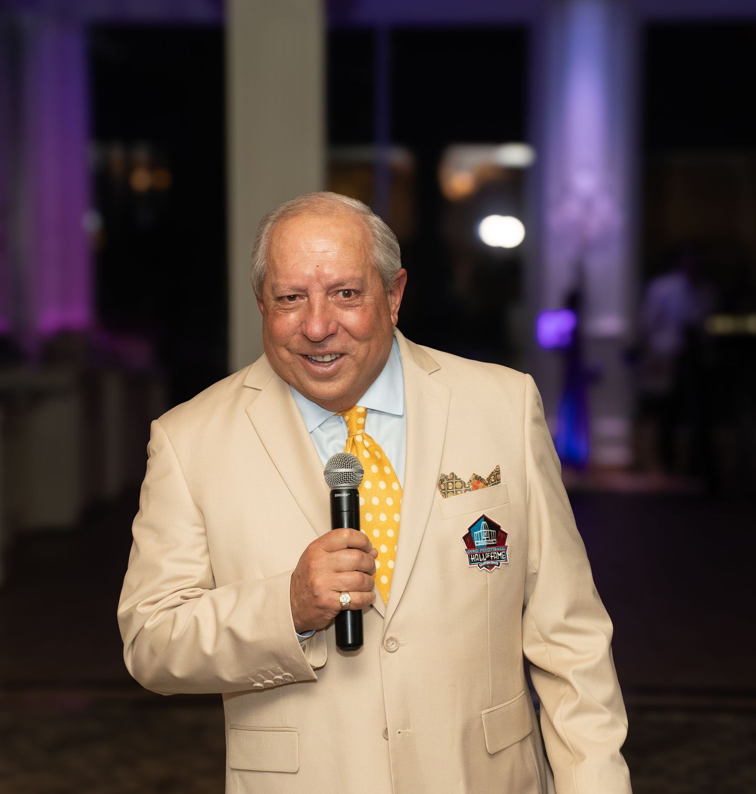 client in attire speaking at an event