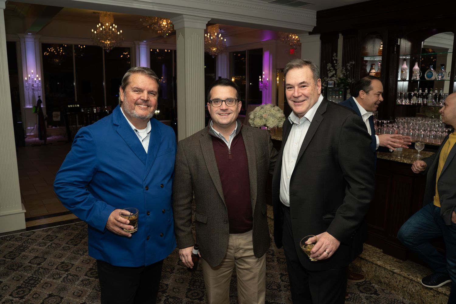 Group gathering at an evening event with mood lighting and cocktails.