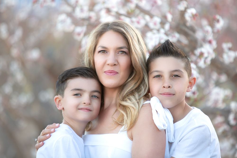 Las Vegas Motherhood Portrait Photographer Merrick Imagery captures stunning photo with sons at the Gilcrease Orchard with beautiful blooms