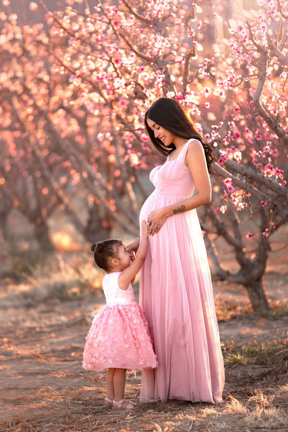 Mom embracing her daughter among the cherry blossoms in Las Vegas captured by Merrick Imagery