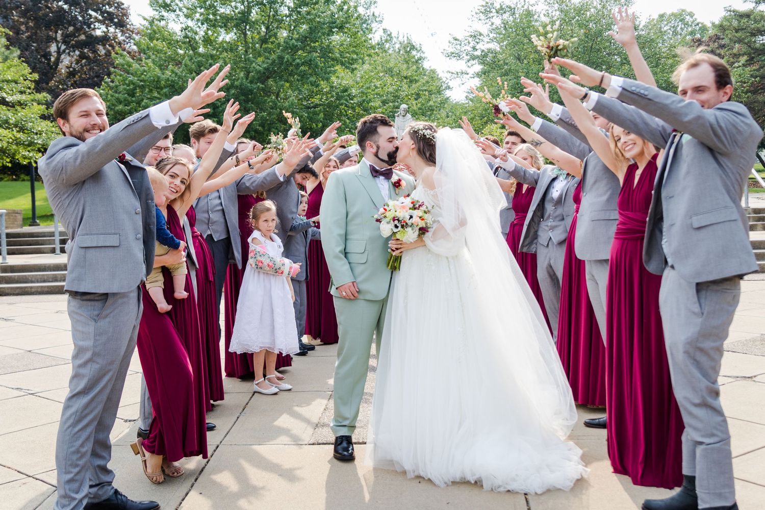 Bride and Groom Kissing Bridal Party Tunnel