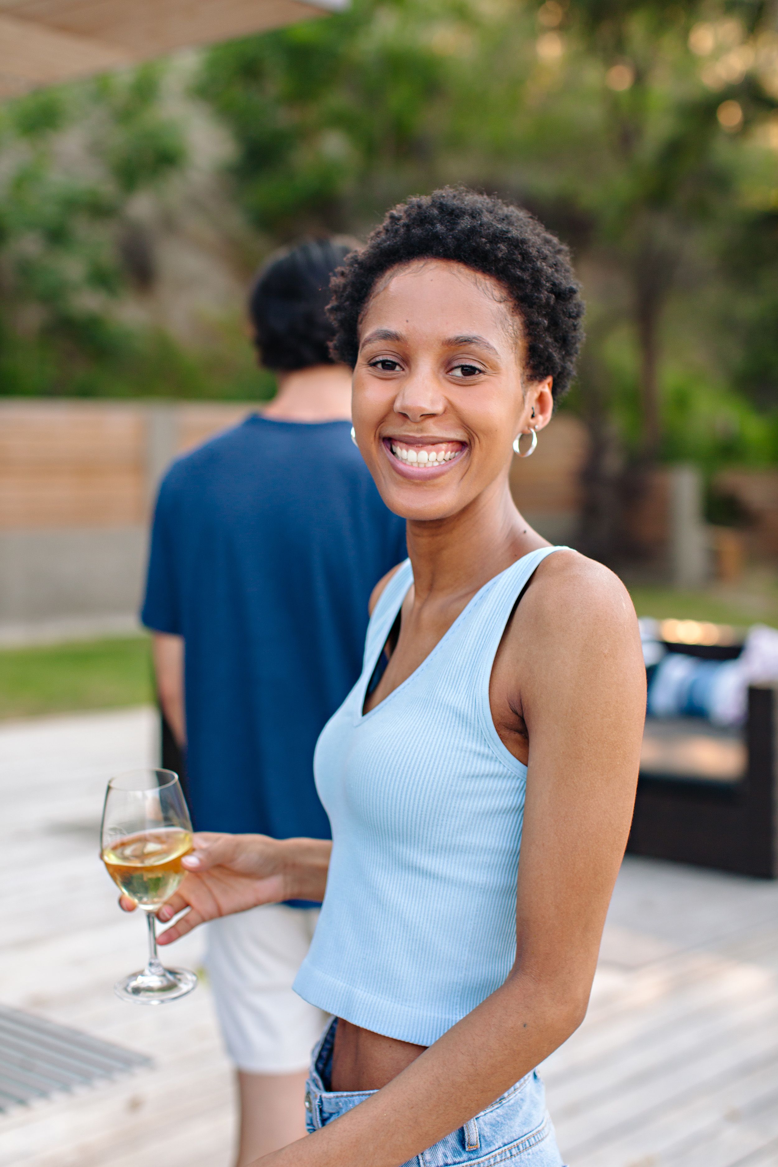 girl laughing while holding wine
