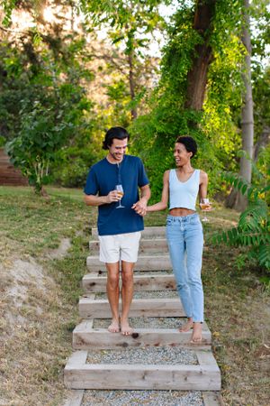 couple holding hands and laughing on stairs