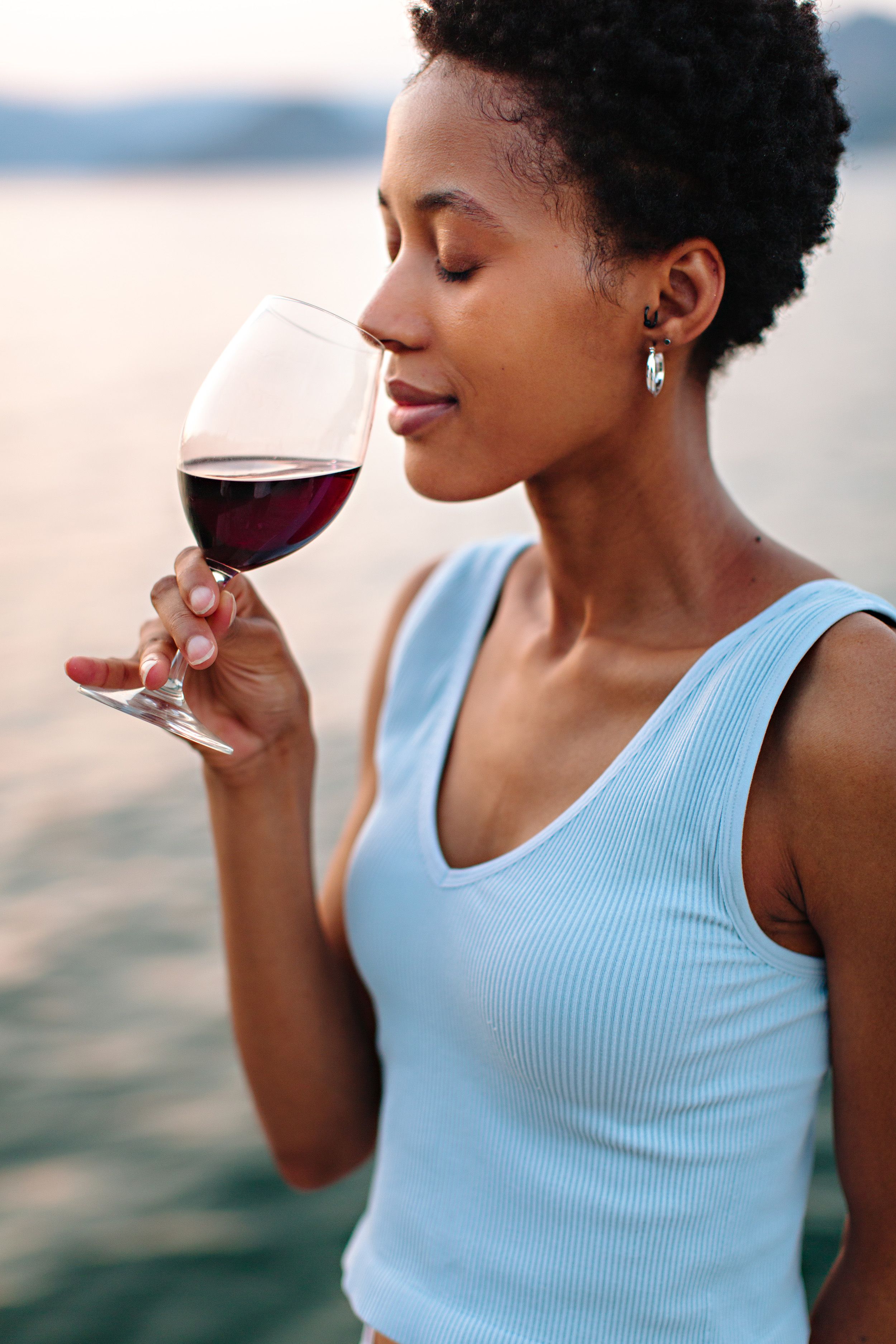 girl smelling red wine