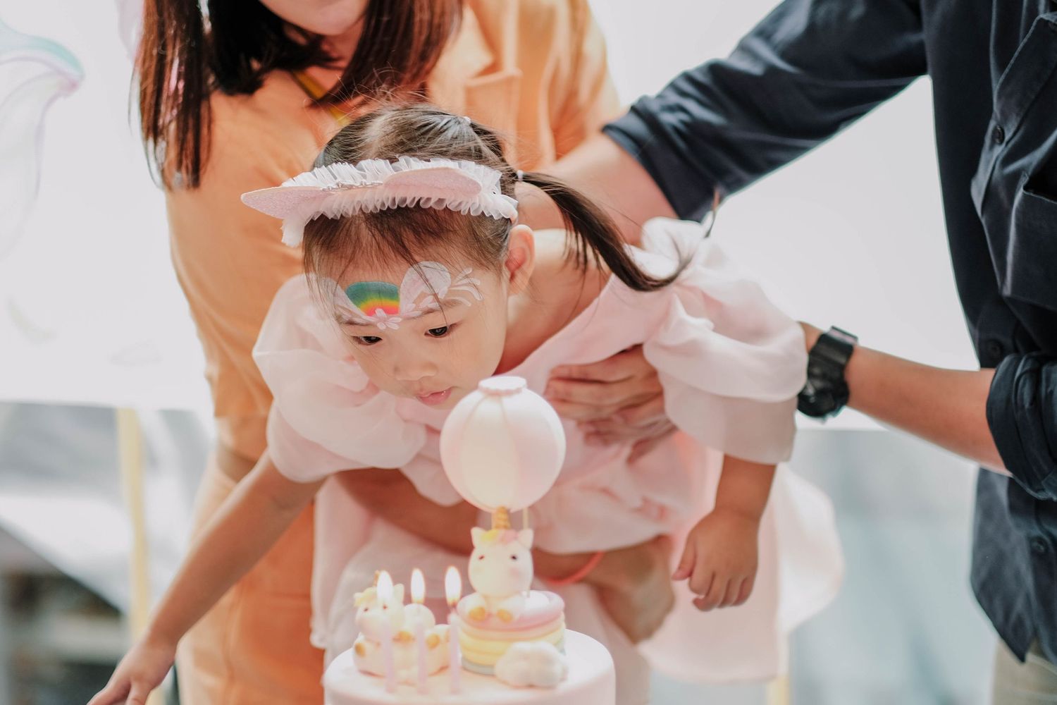 A special moment during a baby celebration with a decorative cake.