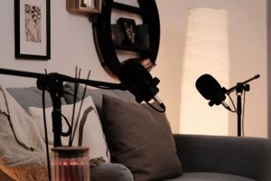 Podcast recording space with professional microphones, mood lighting, and modern wall decor.