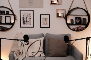 Gallery wall display with minimalist artwork and floating shelves in a contemporary living space.