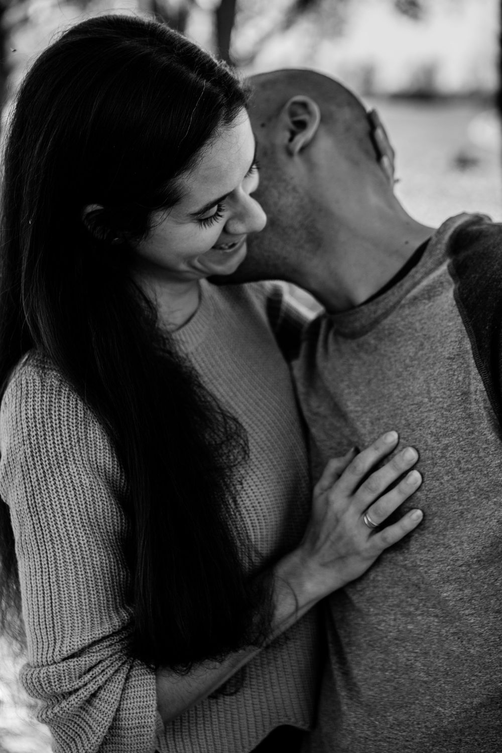 Black and white portrait of couple sharing intimate moment.
