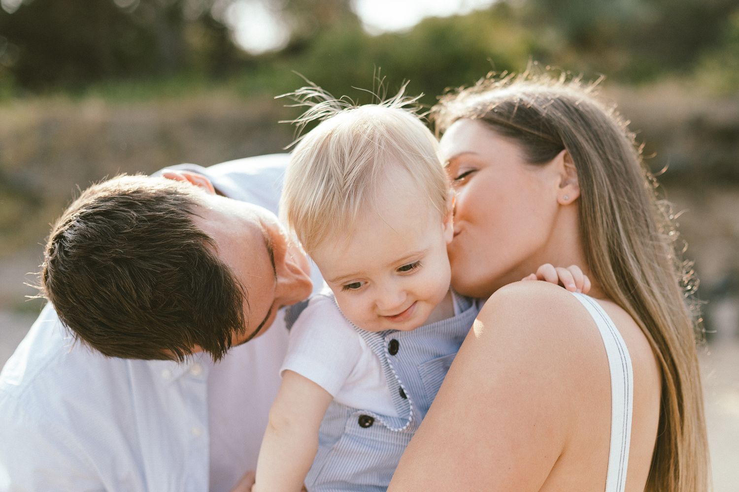 Sweet candid moments between family members during beach sunset session.