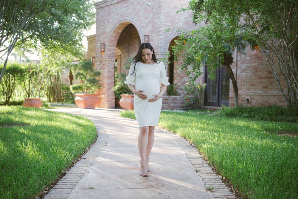 girl walking holding her belly. prenatal session. pregnancy photos. mcallen, Texas. wedding photography