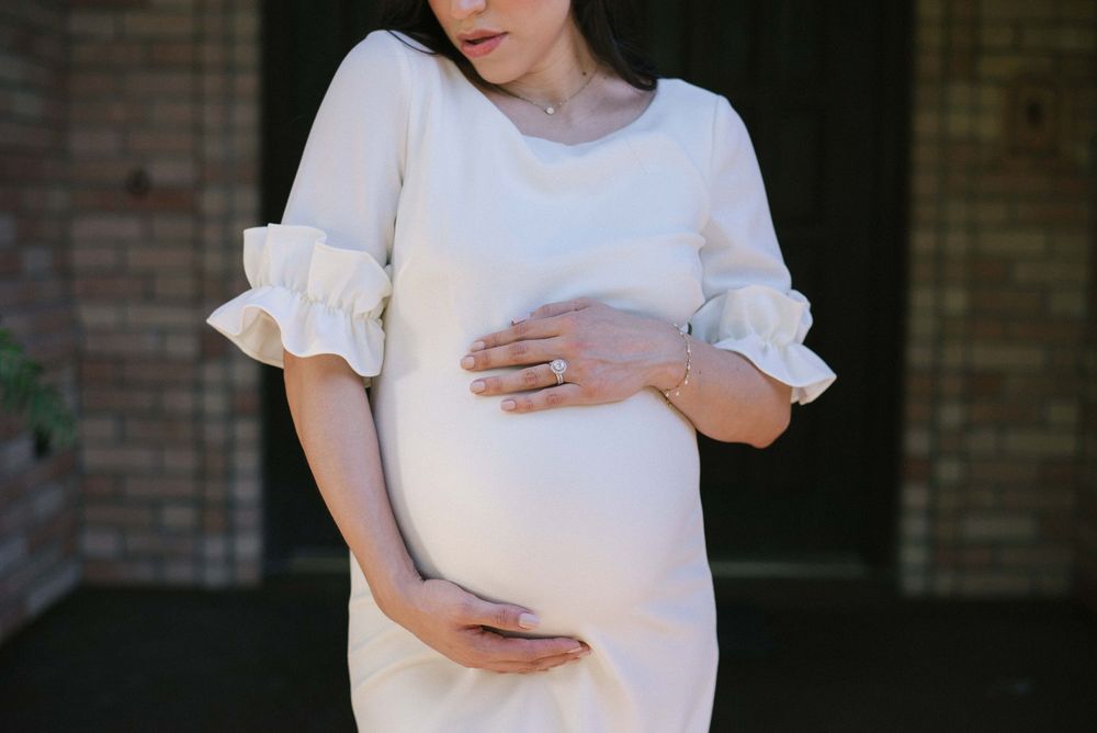 girl looking down holding her belly. prenatal session. pregnancy photos. mcallen, Texas. wedding photography