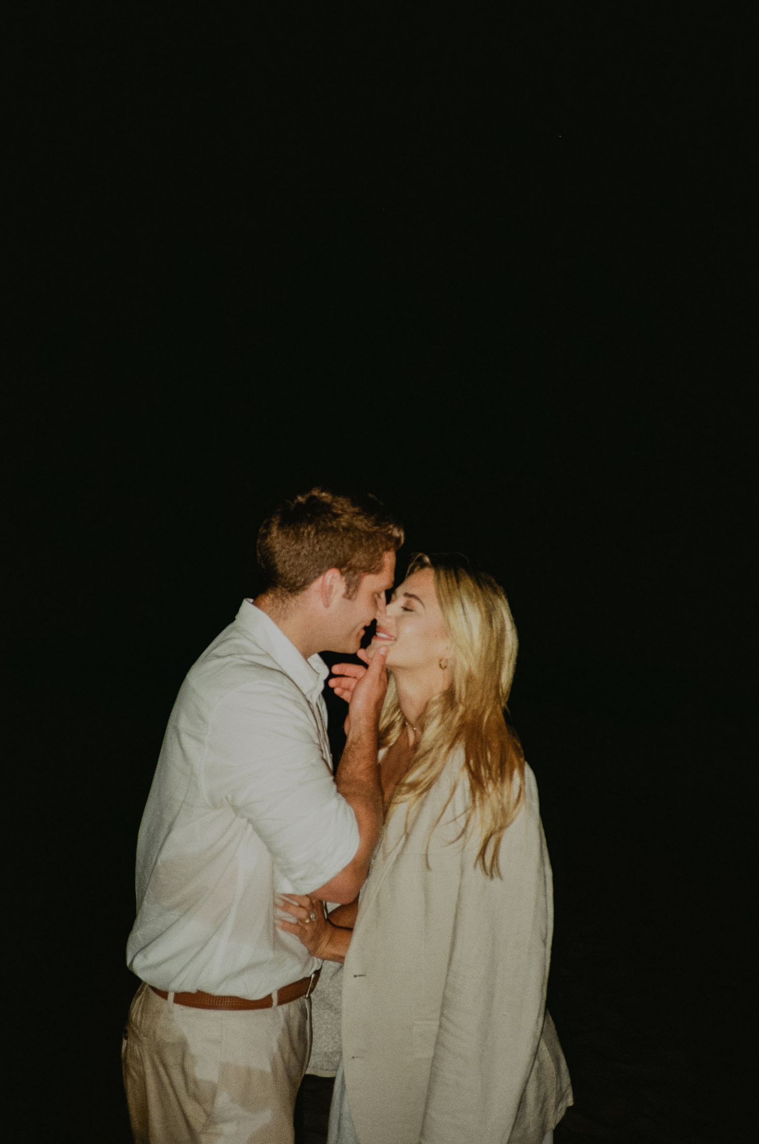 Newport beach sunset couple's engagement shoot on 35mm film camera during blue hour with flash