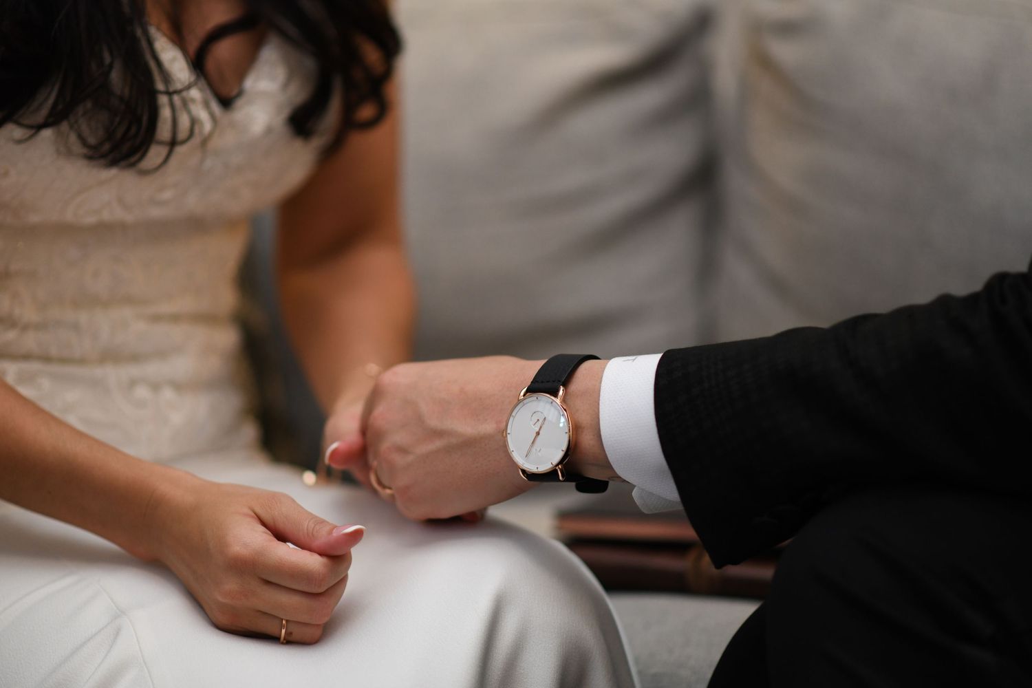 close up detail photo of a groom holding a bride's hand wearing a watch at a hotel in Kansas City Missouri