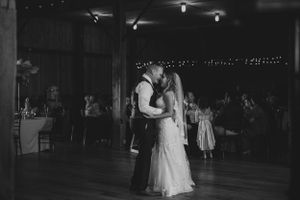 A romantic black and white photo of a couple sharing their first dance at a wedding reception.