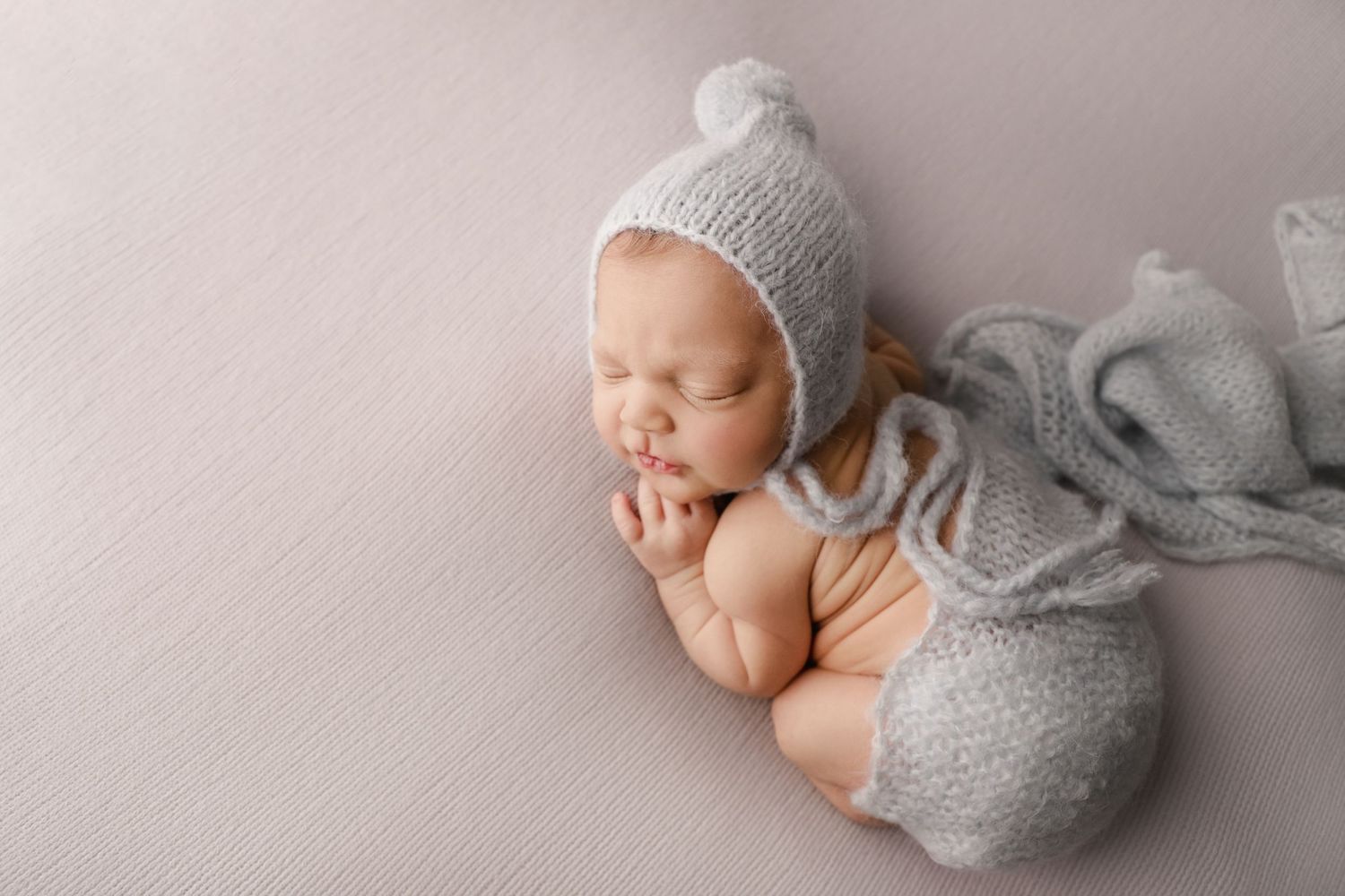 fine art newborn portrait of baby boy with hat in blue