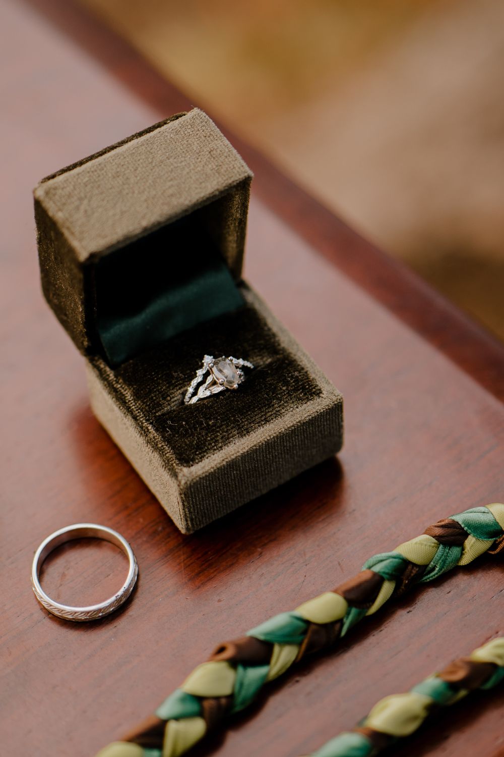 Close shot of the wedding rings on a red table