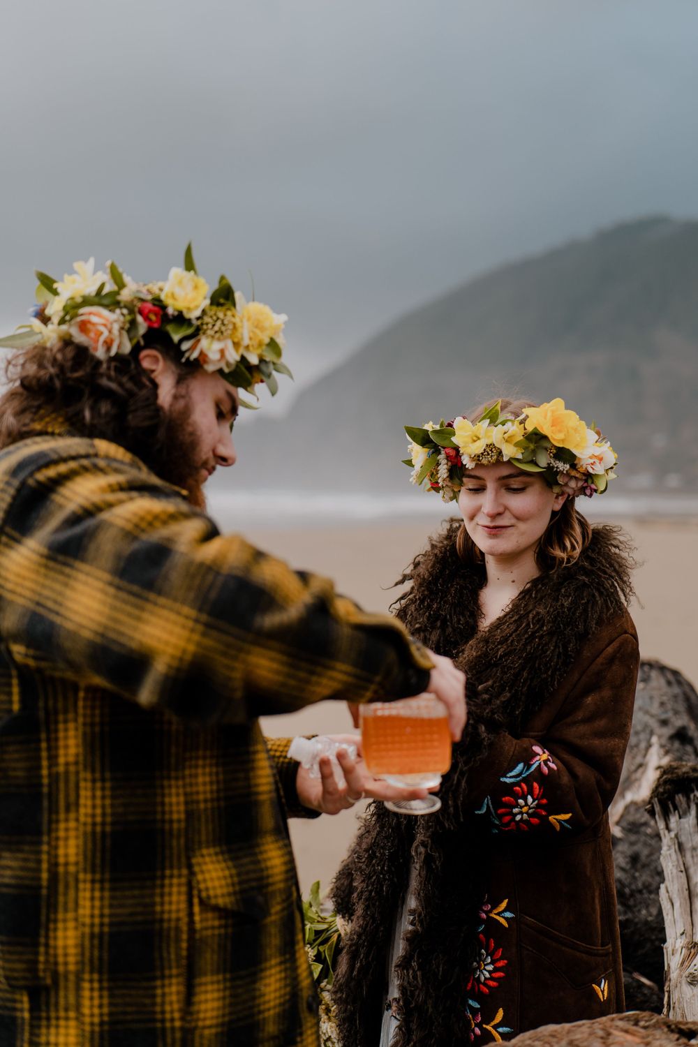 Groom pouring a drink for the bride on the Oregon coast