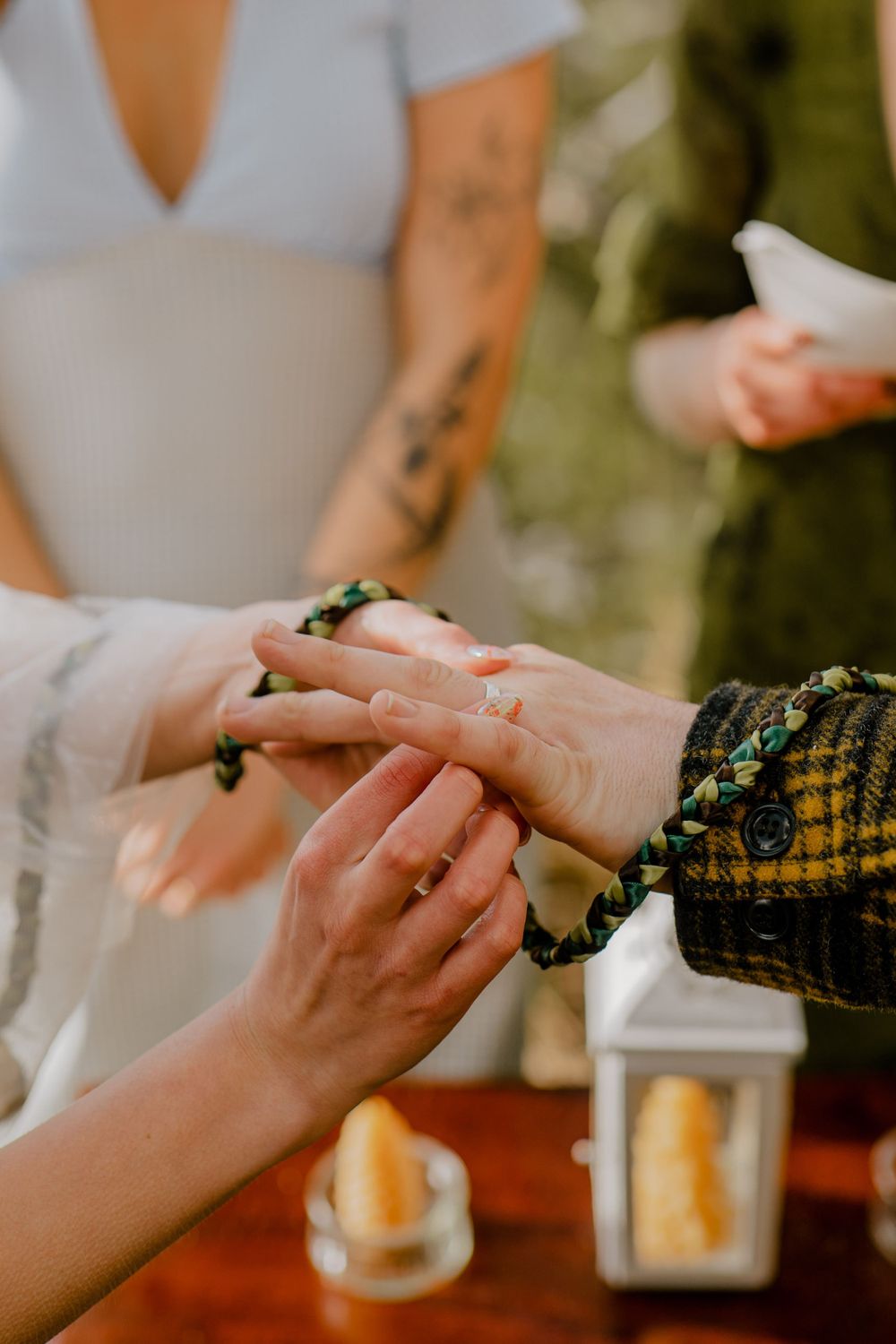 Bride placing grooms wedding ring on his hand