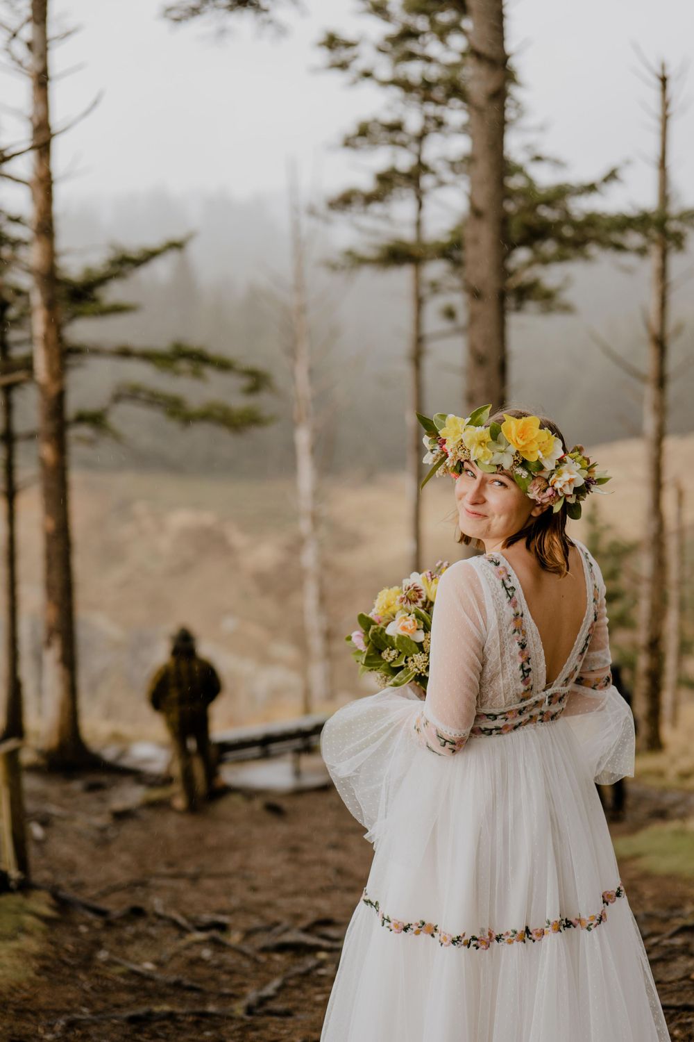 First look with bride looking back and groom facing away in the distance
