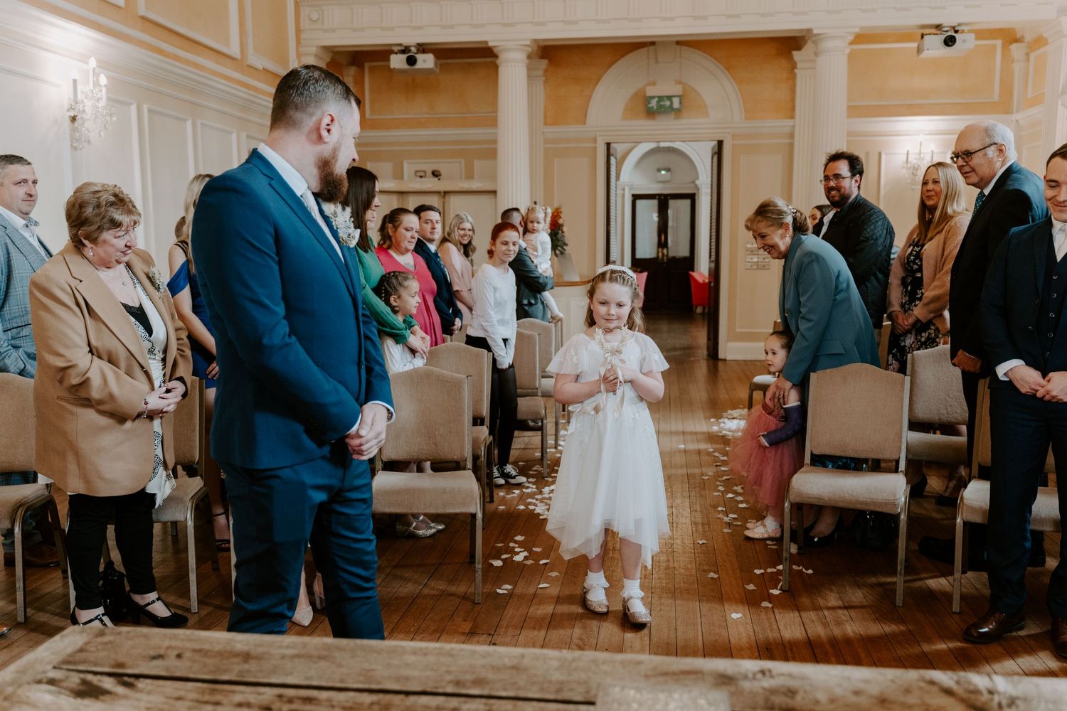 a flower girl walking down the aisle.