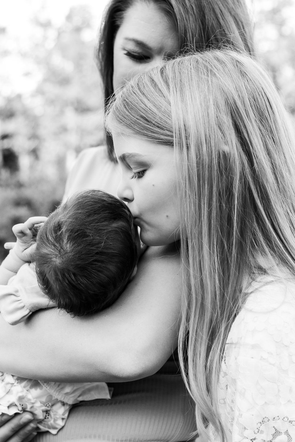 Black and white portraits showing tender embraces between family members.
