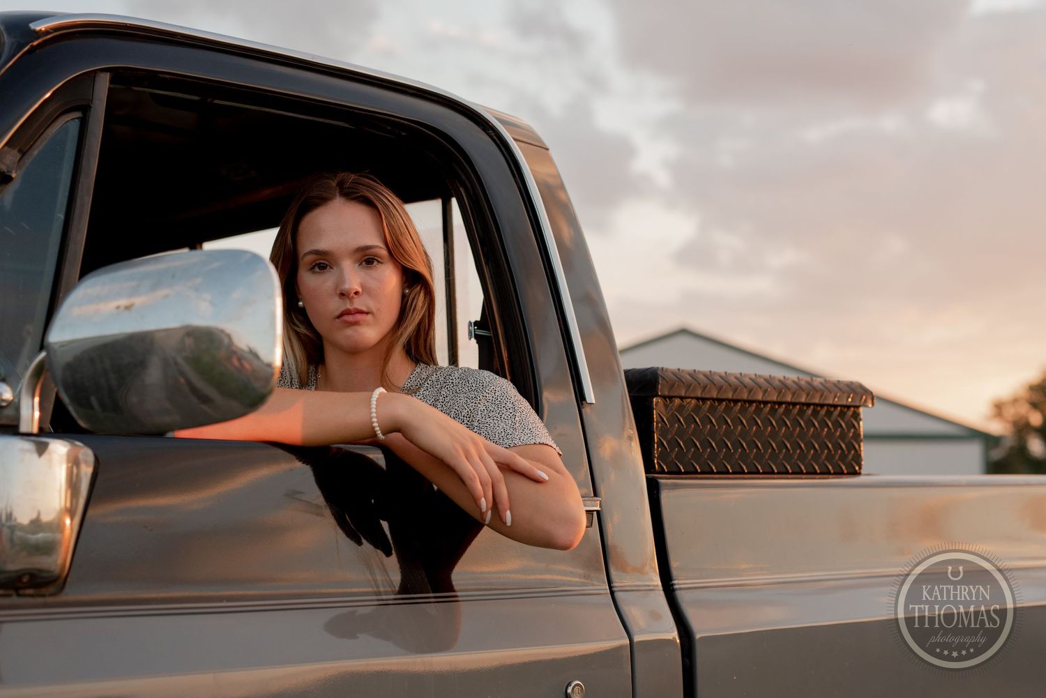 Classic pickup truck portrait against a sunset sky with vintage styling.