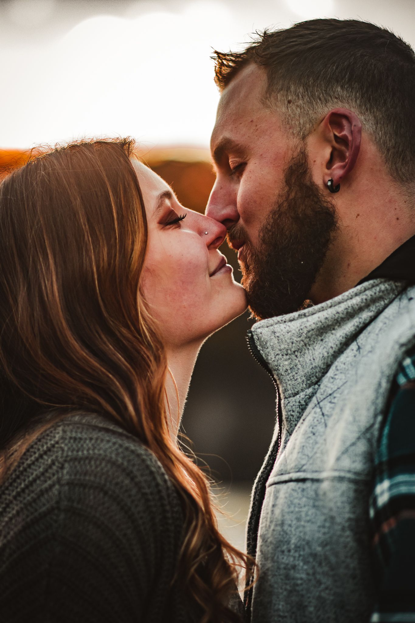 An intimate moment between a couple during a golden sunset.