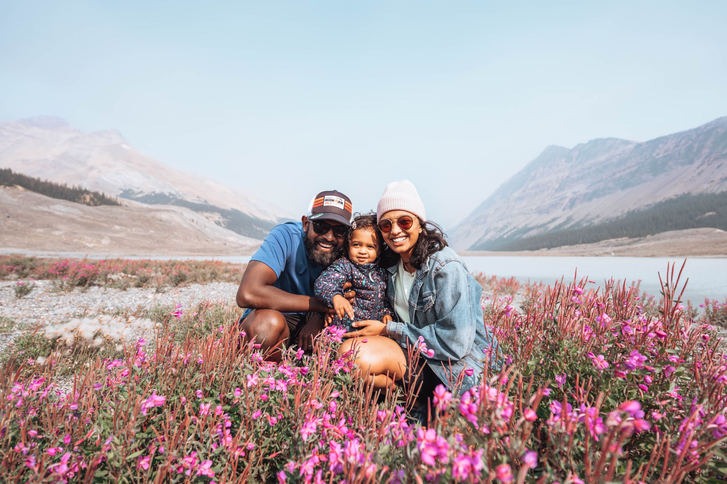 family poses for the camera near Moraine Lake. Banff family photography.