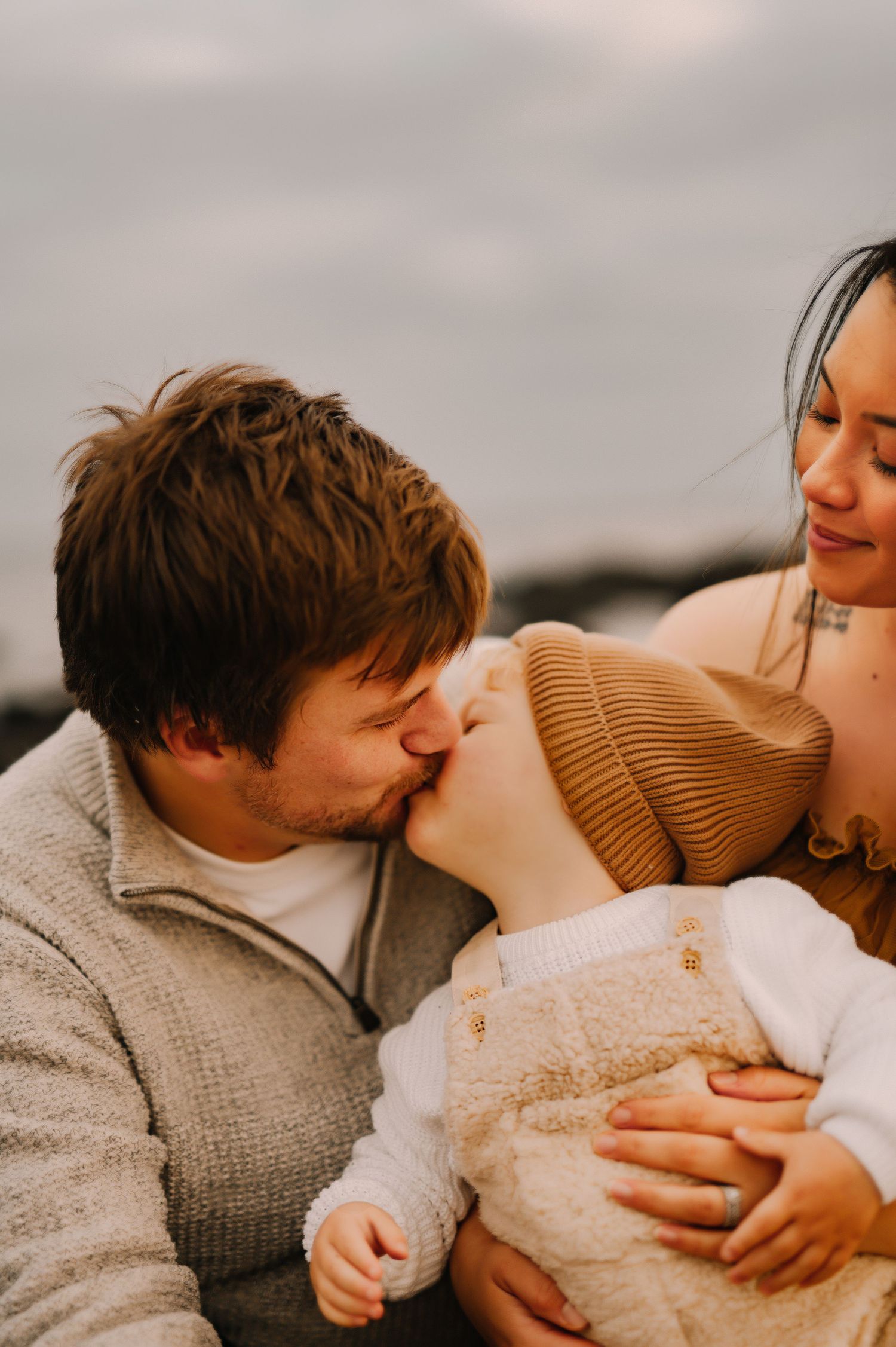 An intimate family moment captured during golden hour outdoors.