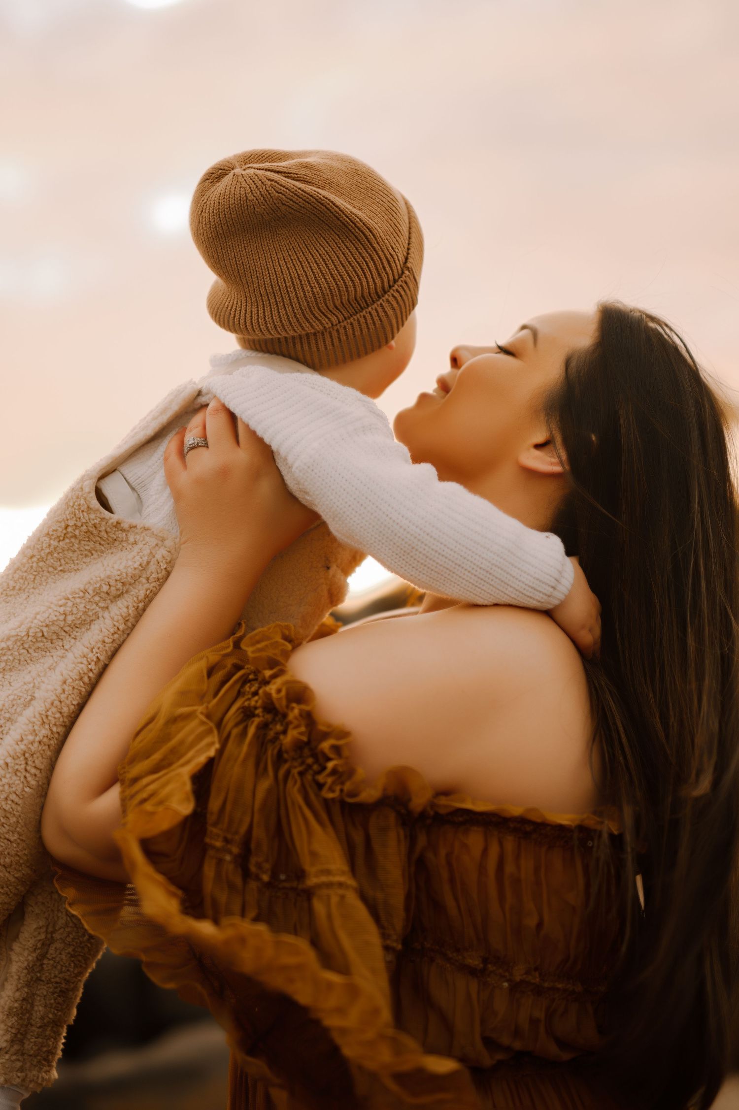 An intimate moment of joy and affection captured in warm golden light.