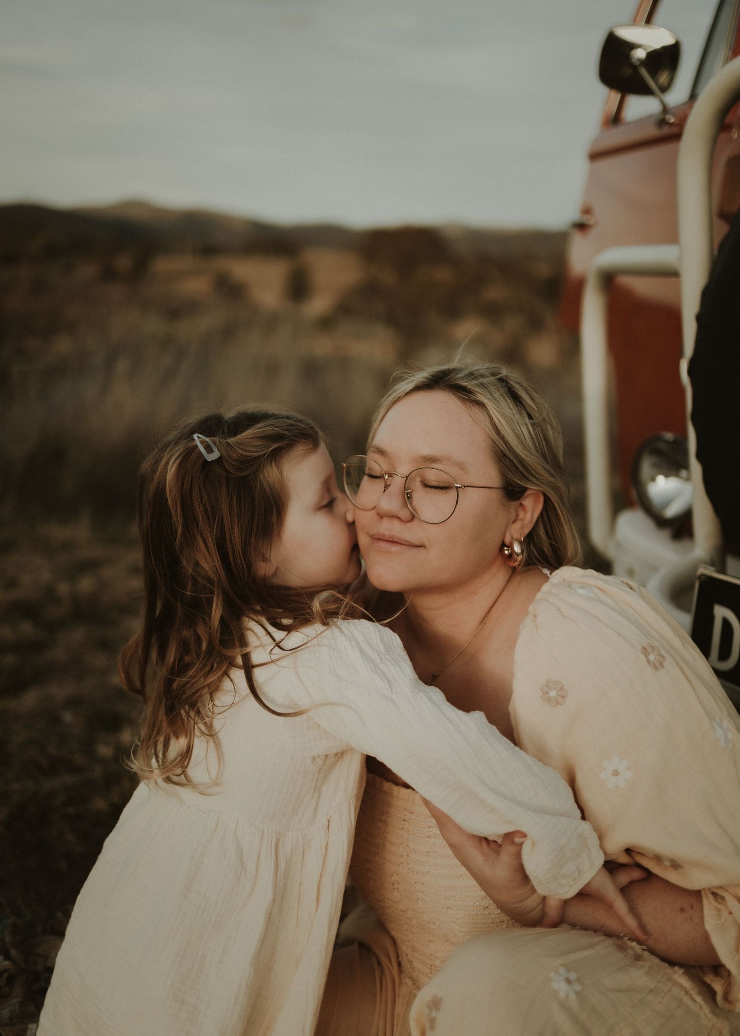 daughter kissing mother on cheek