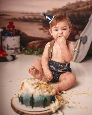 Baby boy eating 1st birthday cake; Lexington, SC birthday photoshoot; best Cake Smash photographer Lexington, SC