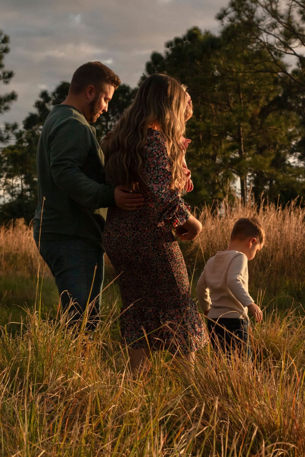 Family laughing together in a field in Stuart, Florida
