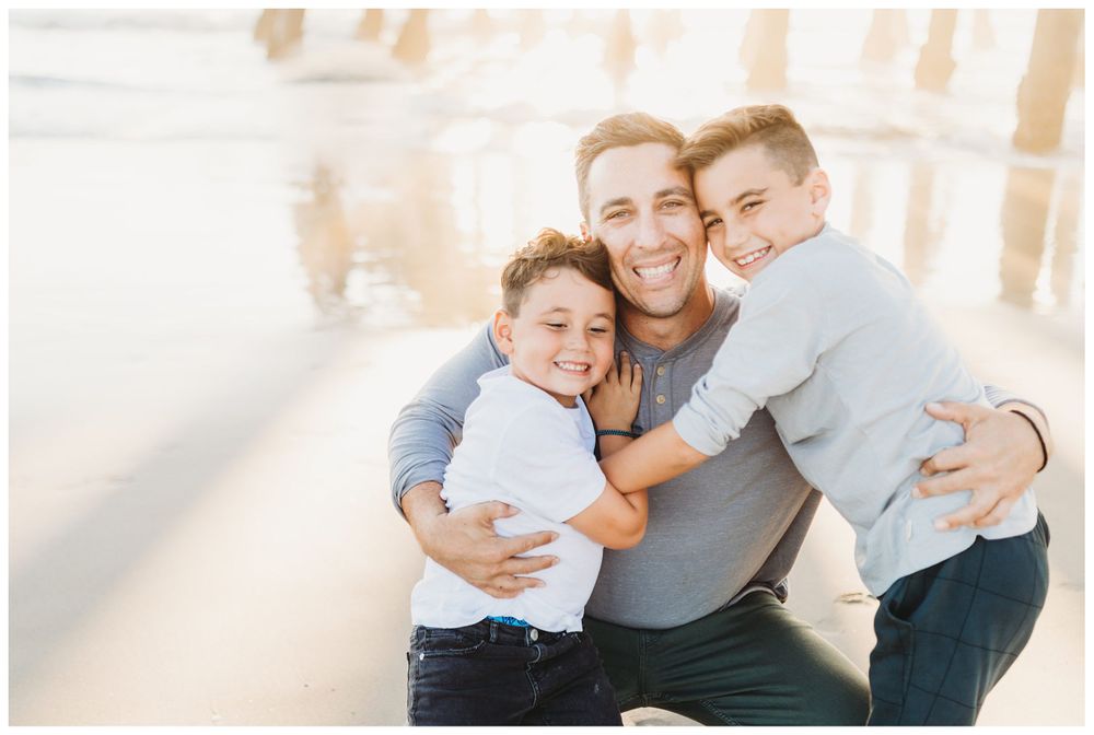 dad hugging two sons