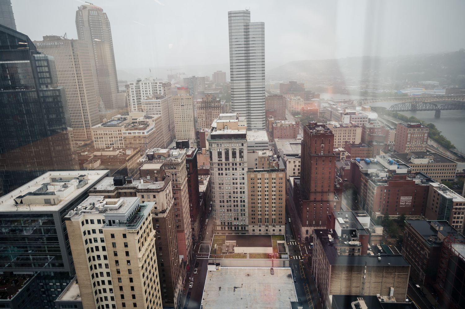 Aerial cityscape view of downtown buildings on a foggy rainy day.