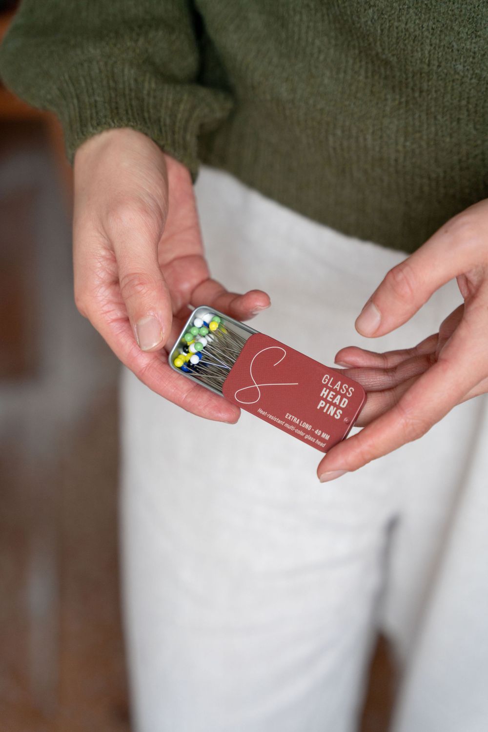 Hands holding a credit or debit card showing steps of proper card handling and storage.