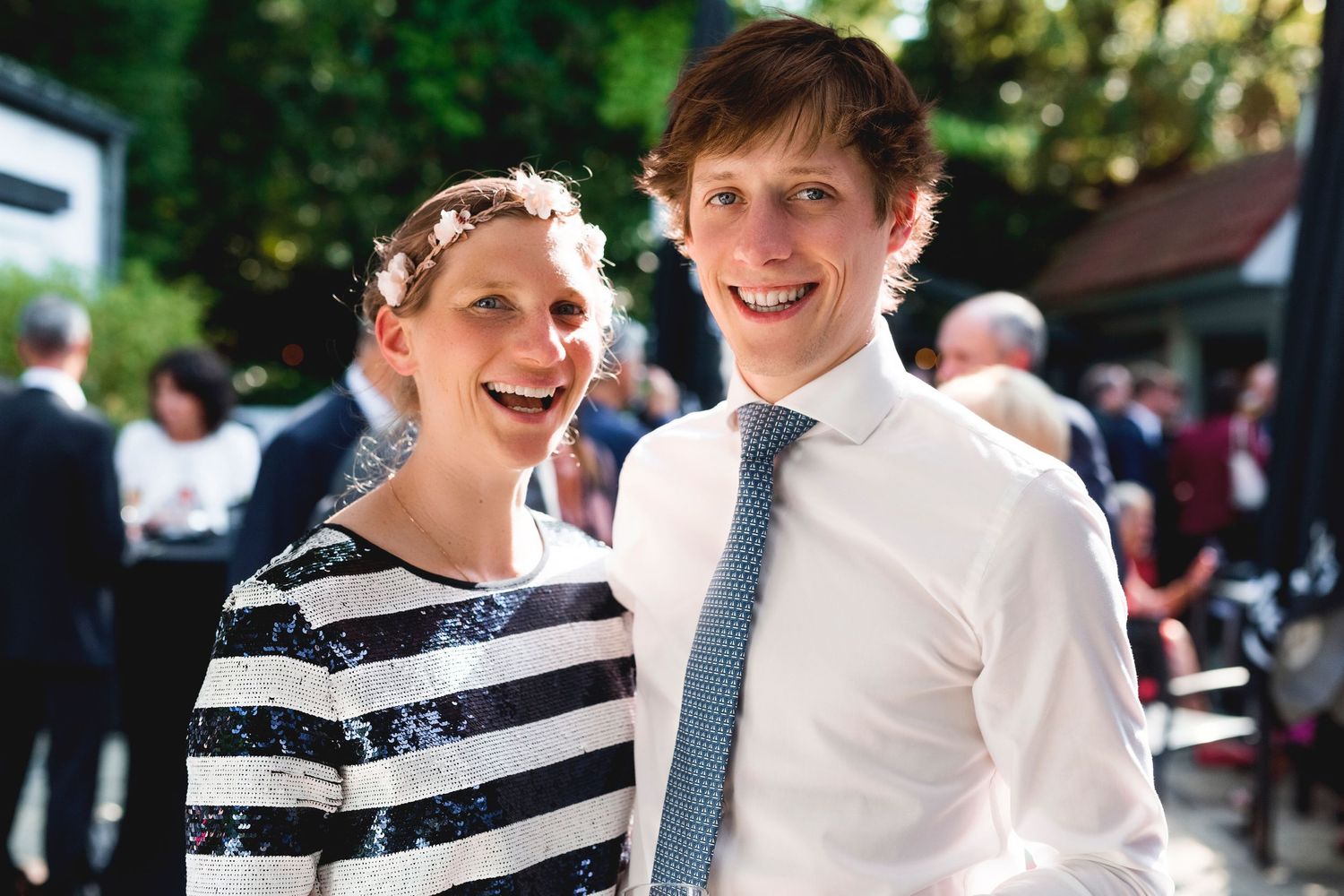 A couple at an outdoor event wearing coordinated black and white outfits.