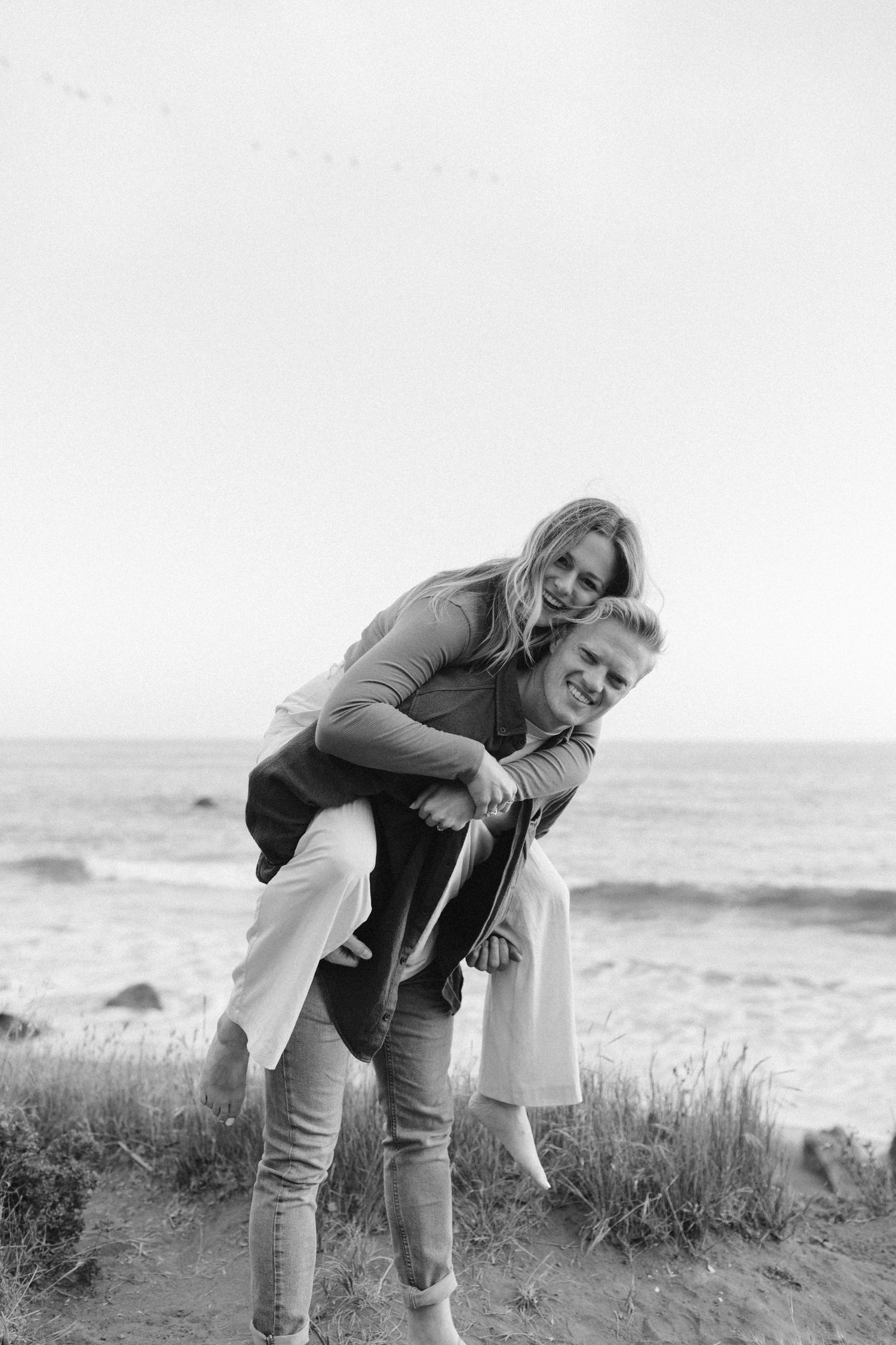 A black and white photo of a piggyback ride along the coastal cliffs.
