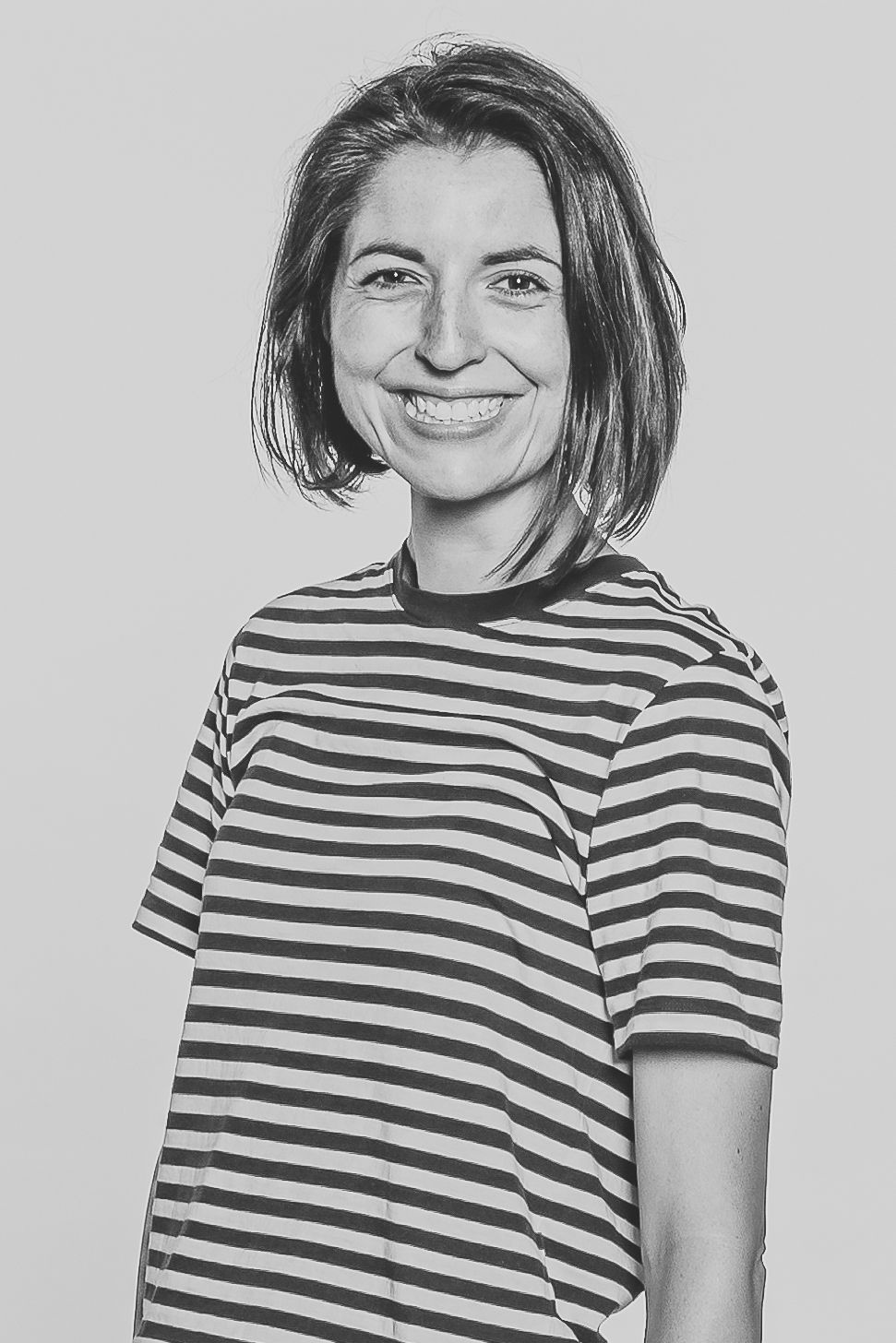 Black and white portrait of person wearing striped t-shirt.