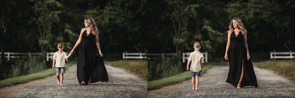 Two figures in flowing black dresses walking down a tree-lined path.